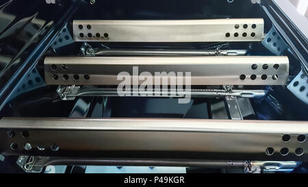 Closeup of Gas Barbecue Grill flavorizer bars covering the grill burners. Stock Photo