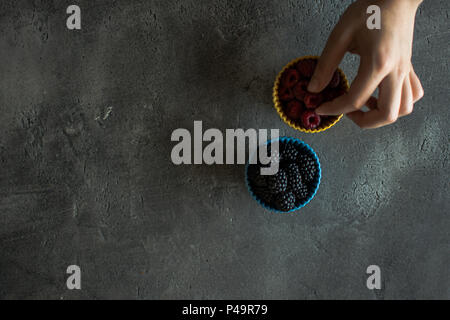 Raspberries and Blackberries in Ceramic Bowls on Rustic Background Stock Photo