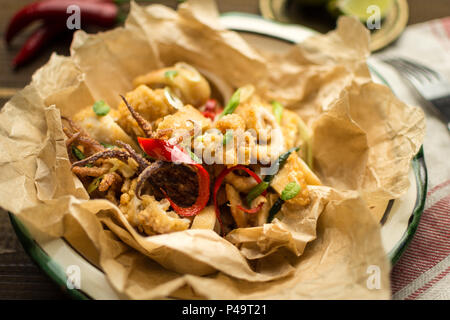 Fresh Greek Squids Calamari with Red Hot Chili Pepper on Rustic Wooden Background Stock Photo