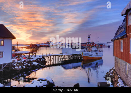 Fishing boat at a small fishing dock at Reine at sunrise in winter, lofoten islands, nordland, norway, europe Stock Photo