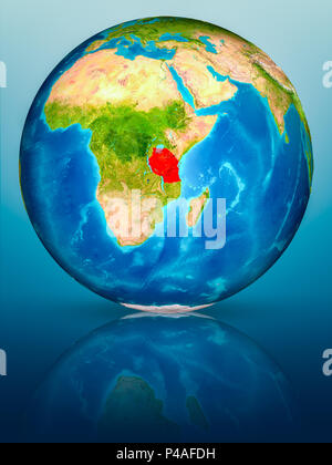 Tanzania in red on model of planet Earth on reflective blue surface. 3D illustration. Elements of this image furnished by NASA. Stock Photo