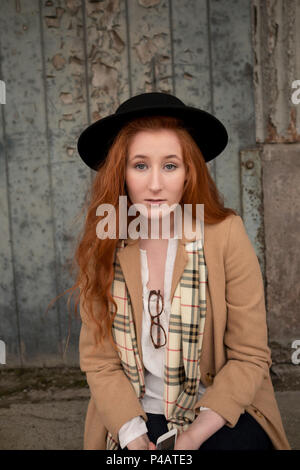 Woman relaxing on a sidewalk in the city Stock Photo