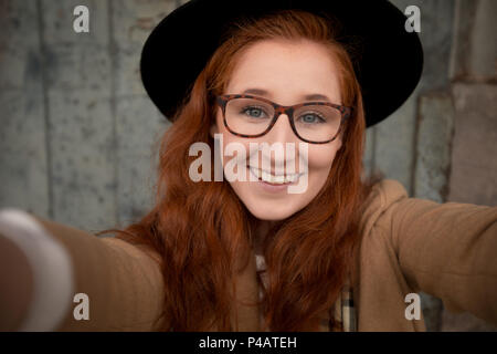 Woman relaxing on a sidewalk in the city Stock Photo