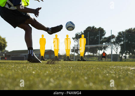 Player kicking soccer in the sports field Stock Photo