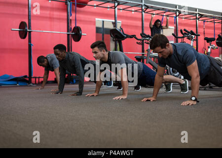 Athletes doing push up in the gym Stock Photo