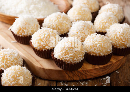 Brazilian coconut kisses (beijinhos de coco — also known simply as beijinhos or branquinhos) are traditionally made from a mixture of sweetened conden Stock Photo