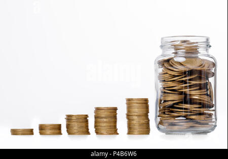Plant growing in bag of coins Stock Photo