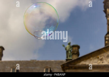 Bubbles float through the sky above Dam Square, Amsterdam, Netherlands. Stock Photo