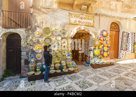 Man having a look at a pottery store in Erice, Trapani province, Sicily, Italy Stock Photo