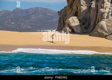 Surfer at Beach of love and divorce in Cabo San Lucas in the state of Baja California Sur in northern Mexico Stock Photo