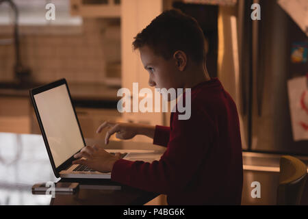 Boy using laptop at home Stock Photo