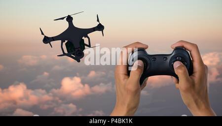 Man flying a drone silhouette in sky Stock Photo