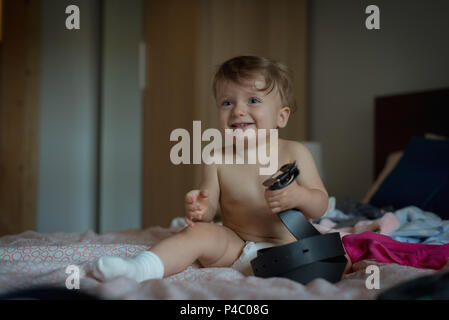 Baby boy playing on bed Stock Photo