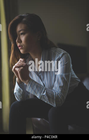 Thoughtful businesswoman sitting on armchair Stock Photo