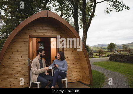 Couple relaxing in log cabin Stock Photo
