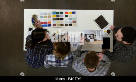 Architects and designers working and multitasking in the office Stock Photo