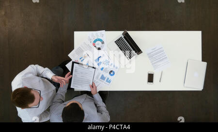 Two managers discussing contract in the office Stock Photo