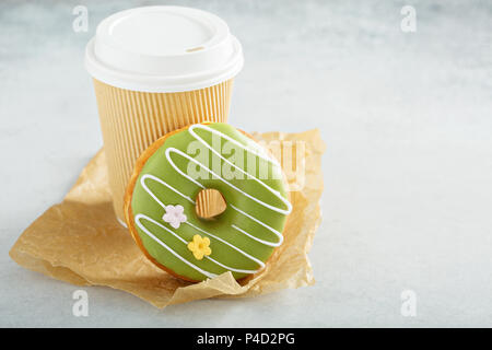 Green matcha glazed donut with cherry Stock Photo
