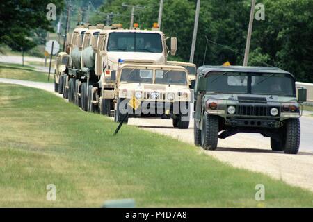 Military vehicles are parked on the cantonment area for use in the 86th Training Division’s Combat Support Training Exercise 86-18-04 on June 14, 2018, at Fort McCoy, Wis. The exercise is part of the Army Reserve's Combat Support Training Program, or CSTP. CSTP exercises are large-scale, collective-training exercises designed to immerse units into tactical training environments that closely replicate what they might experience in operational deployments. The 86th Training Division is a tenant organization at Fort McCoy. (U.S. Army Photo by Scott T. Sturkol, Public Affairs Office, Fort McCoy, W Stock Photo