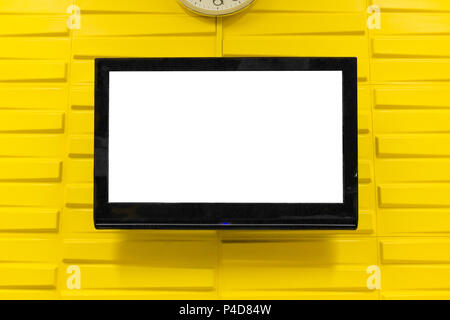Big black television on modern yellow wallpaper background. Stock Photo