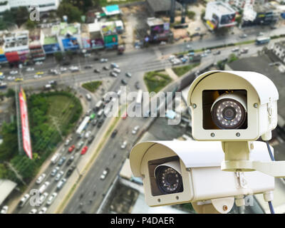 The CCTV Security Camera operating on traffic road blur background. Stock Photo