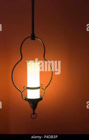 Vintage lamp design on orange wall background. Stock Photo