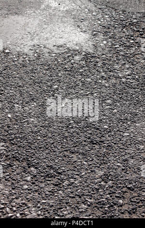 Aged coarse asphaltic road surface abstract texture close up Stock Photo