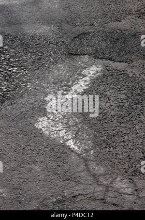 Aged coarse asphaltic road surface abstract texture close up Stock Photo