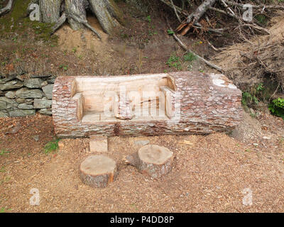 Dunkeld, Scotland, UK - August 16, 2013: Some garden carvings from an old tree trunk that have been thoughtfully carved out of fallen trees within the Stock Photo