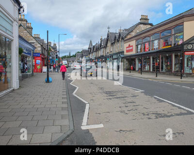 Pitlochry, Scotland, UK - August 19, 2013: People and traffic on a quiet summer afternoon in Pitlochry Scotland. Stock Photo