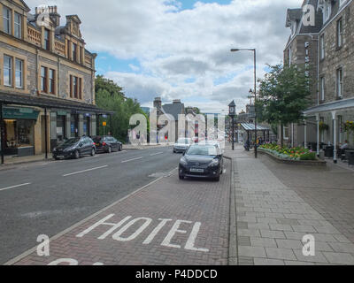 Pitlochry, Scotland, UK - August 19, 2013: People and traffic on a quiet summer afternoon in Pitlochry Scotland. Stock Photo