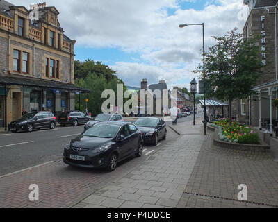 Pitlochry, Scotland, UK - August 19, 2013: People and traffic on a quiet summer afternoon in Pitlochry Scotland. Stock Photo