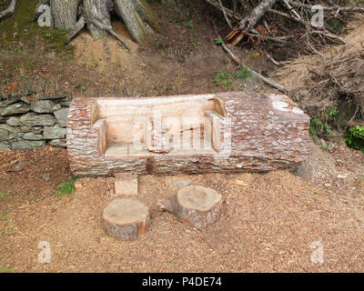 Dunkeld, Scotland, UK - August 16, 2013: Some garden carvings from an old tree trunk that have been thoughtfully carved out of fallen trees within the Stock Photo