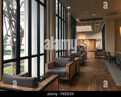 Modern interior room design with small sofa set, in the cafe background. Stock Photo