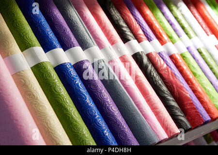 Rolls of colored festive wrapping paper in shop Stock Photo