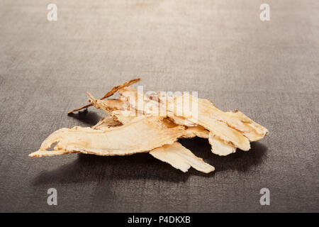 Angelica root used in chinese traditional herbal medicine over black background. TCM. Stock Photo