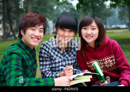 three asian college students study together in campus Stock Photo
