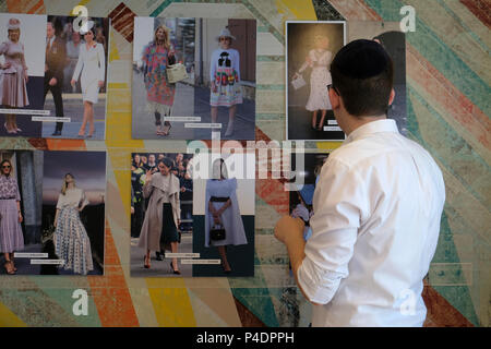 Bnei Brak, Israel. 20th June, 2018. An ultra orthodox Jew looking at magazine tear sheets with photos of celebrity figures and Haredi women wearing fashionable clothing hanged  at the only school for fashion and styling professions in the Haredi sector which Miri Beilin a Haredi Designer and Stylist opened in the city of Bnei Brak or Bene Beraq a center of Haredi Judaism in Israel Stock Photo