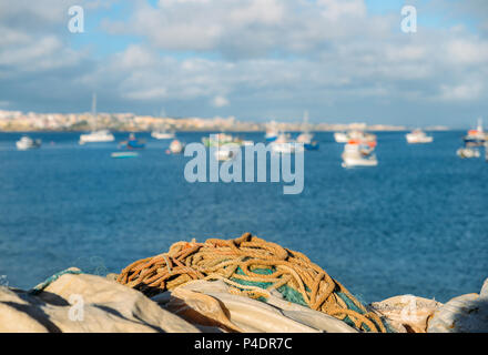 fishing nets, sea and village view on the background, selective focus - captured in Cascais, Portugal Stock Photo