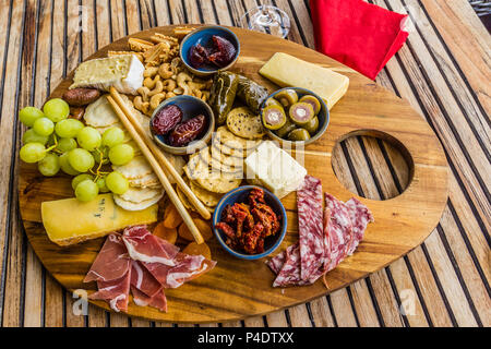 Wooden platter with a serving of antipatsto. Stock Photo