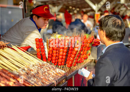 BEIJING, CHINA - MARCH 11, 2016: Food vendors offers its products at the Donghuamen Night Market near Wangfujing Street in Beijing, China Stock Photo