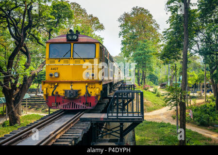 Thai train on the historical bridge over the river Kwai Stock Photo