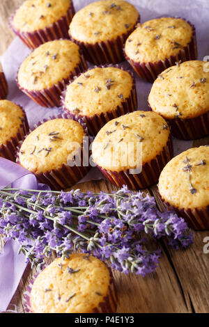 Delicious lavender muffins dessert close-up on the table. vertical Stock Photo