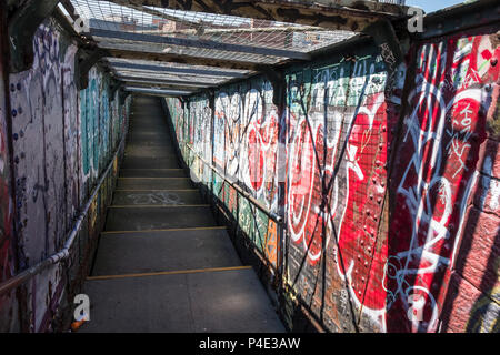 Pedestrian footbridge covered in graffiti, Sheffield, England, UK Stock Photo