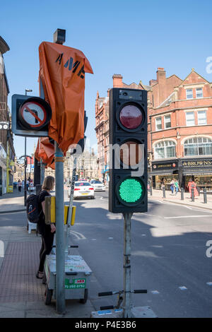 Person waiting to cross the road at temporary traffic signals, Sheffield, England, UK Stock Photo