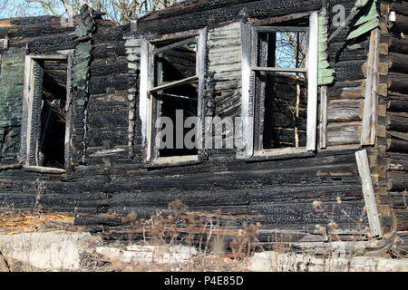 empty window Burnt old wooden house Stock Photo