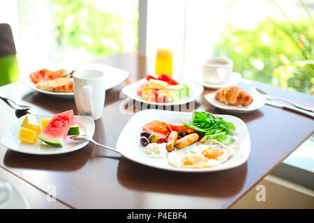 Morning family breakfast with eggs, coffee and fruits. Close up Stock Photo