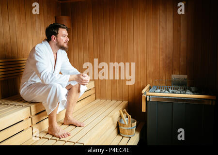 Handsome man relaxing in sauna Stock Photo