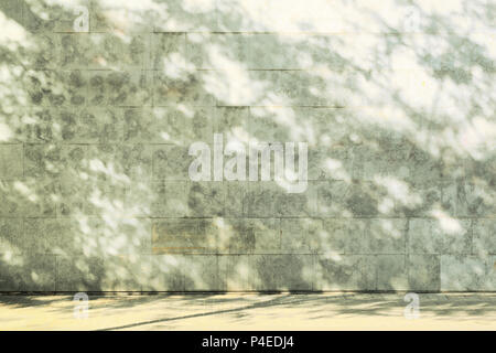 Stone wall and sidewalk with some tree shadows. Empty copy space for Editor's text. Stock Photo