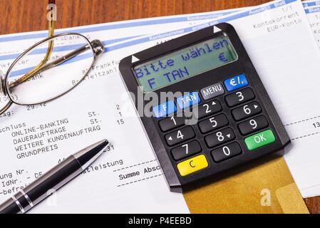 Tan generator with check card and statement of bank account | usage worldwide Stock Photo